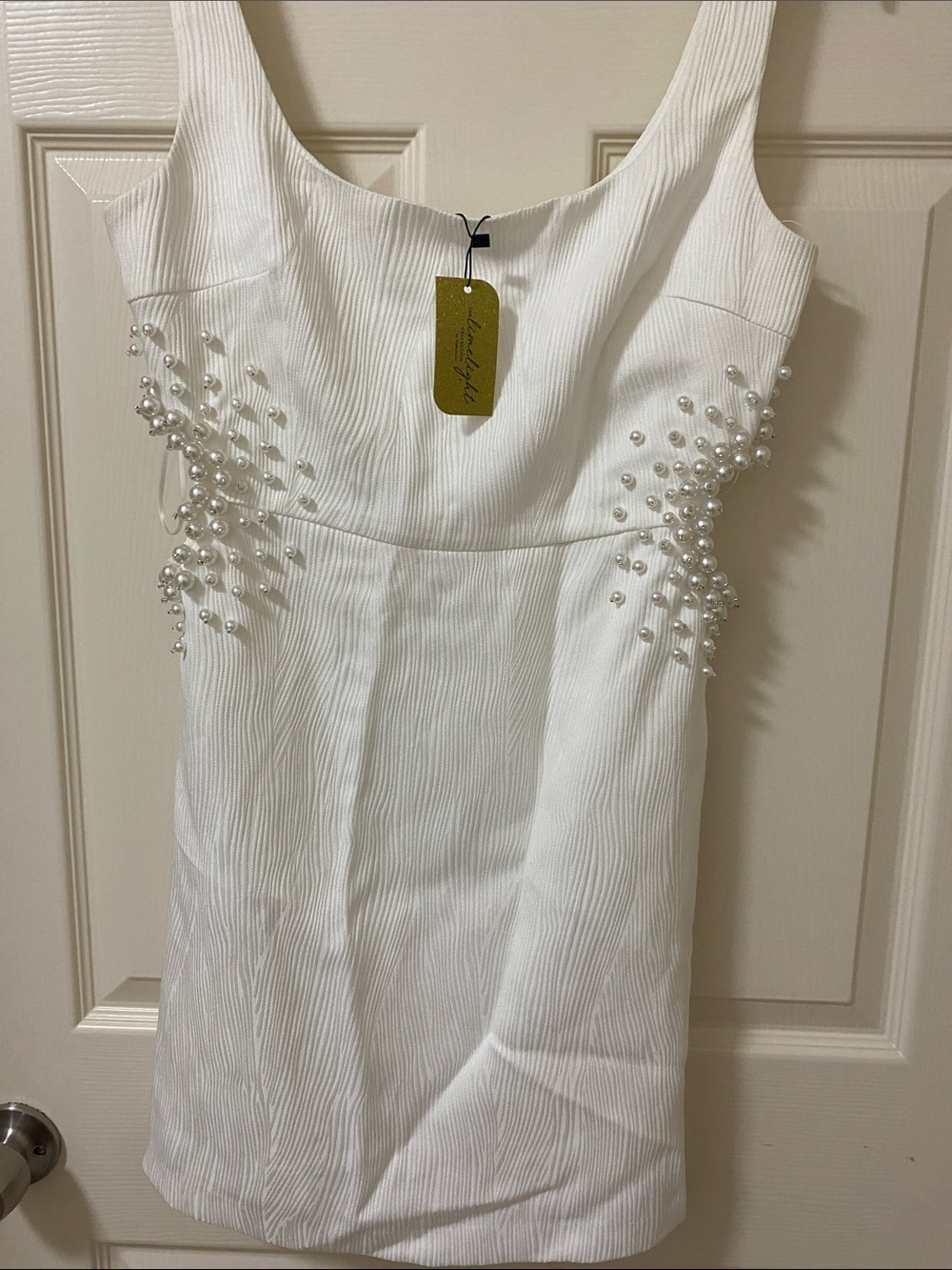Francesca's White Pearl-Accent Sleeveless Dress from the Limelight Collection .